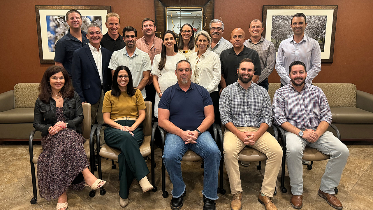 Group photo of almond industry professionals in a meeting room